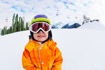 Fototapeta na wymiar Close-up of smiling boy wearing ski mask in winter