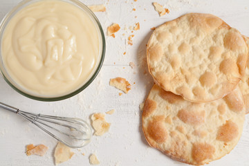 Custard cream on white vintage background. Preparation of sweet