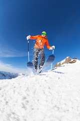 Young man skiing in motion view from below