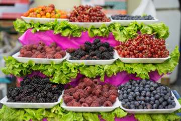 Berries trays in the market, focus on foreground