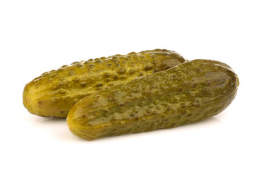 bunch of green pickles on a white background