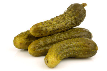 bunch of green pickles on a white background