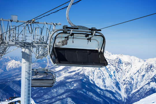Close view of chairlift and mountains on resort