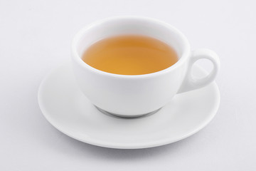 white tea cup with green tea on white background