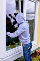 Einbrecher an einem Fenster