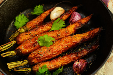 Whole baked young carrot with garlic and rosemary