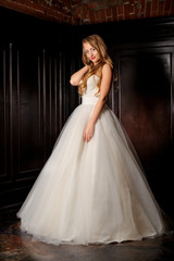 Full-length beautiful Bride in wedding dress. Studio.
