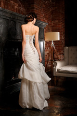 Full-length beautiful Bride in wedding dress. Studio.