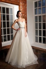 Full-length beautiful Bride in wedding dress. Studio.