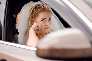 Bride blonde in a wedding car