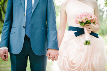 The bride and groom holding hands