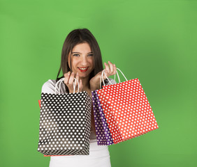 Happy young girl after shopping in studio