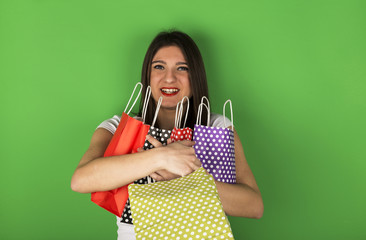 Young girl with spotty designed bags in studio