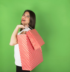 Happy young girl after shopping in studio