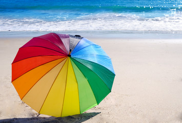 Rainbow umbrella by the ocean © ellensmile