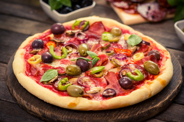 Homemade pizza with ham, cheese and vegetables