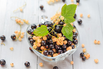 Fruits white black currants saucer wooden table Summer harvest
