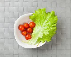fresh vegetables on plate, grey place mat background
