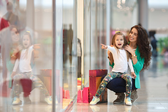 Young Mother And Her Daughter Doing Shopping Together