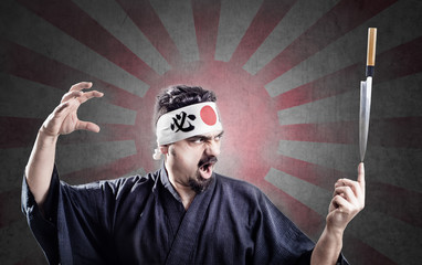 sushi chef keeps a knife in equilibrium on a finger
