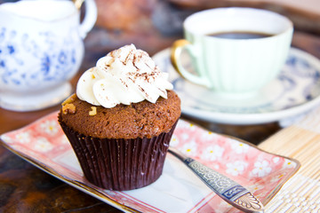 Hot coffee with chocolate cup cake on wooden table