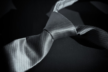 Necktie on black background in style of Fifty Shades of Grey