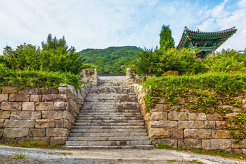 Fototapeta na wymiar Stone wall with stairs to monk temple