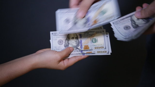 Close up of paying cash