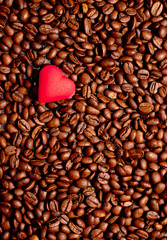 a red heart on coffee beans