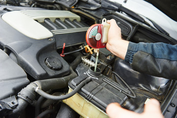 auto mechanic tests car antifreeze liquid