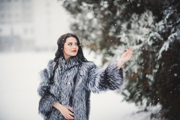 winter portrait of Beauty girl with snow