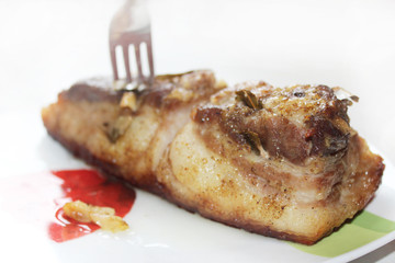 baked piece of meat on the plate
