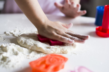 Obraz na płótnie Canvas Child hands playing with dough