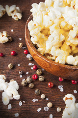 Fototapeta na wymiar Fresh popcorn in bowl on white wooden table. Selective focus.