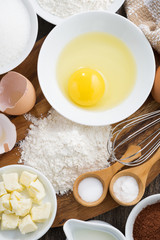 Baking ingredients on a wooden board, vertical, top view