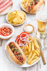 fast food - hot dog with French fries, beer and snacks, vertical