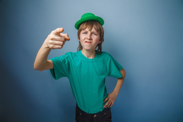 European-looking boy of ten years discontent is pointing at the