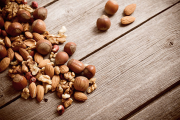 Mixed nuts on old wooden background