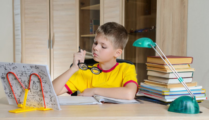 Boy With Funny Glasses Doing Homework. Education concept.