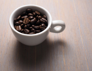 Coffee crop beans in white espresso cup