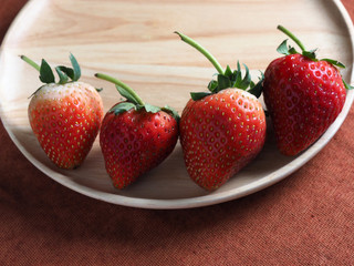 Fresh strawberry on wood plate
