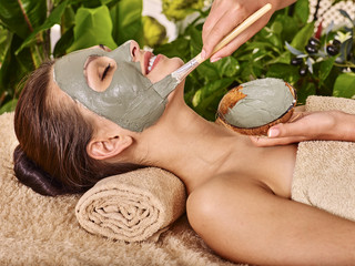 Clay facial mask in beauty spa.
