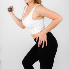 Woman doing fitness exercise with a hand weights.