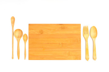 Wooden cutting board with wooden spoon and fork isolated