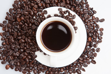Cup of coffee on beans.