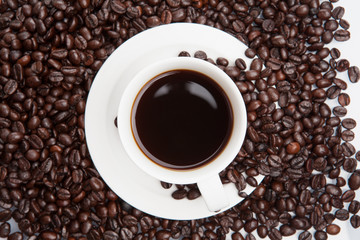 Cup of coffee on beans.