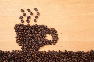 Roasted coffee beans in coffee cup shape