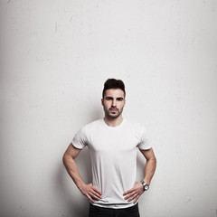 Man in blank t-shirt, wooden wall background