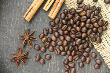 coffee scattered on wooden background with spices