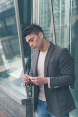 Young handsome man rolling a cigarette